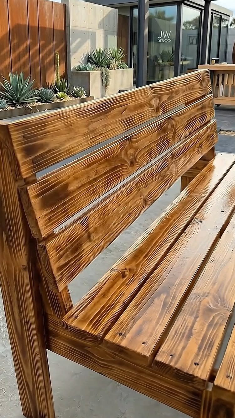 What Can You Do With Burned and Stained Wood? 5 Ideas 1 Wooden outdoor bench with a glossy brown stain and charred wood grain finish.