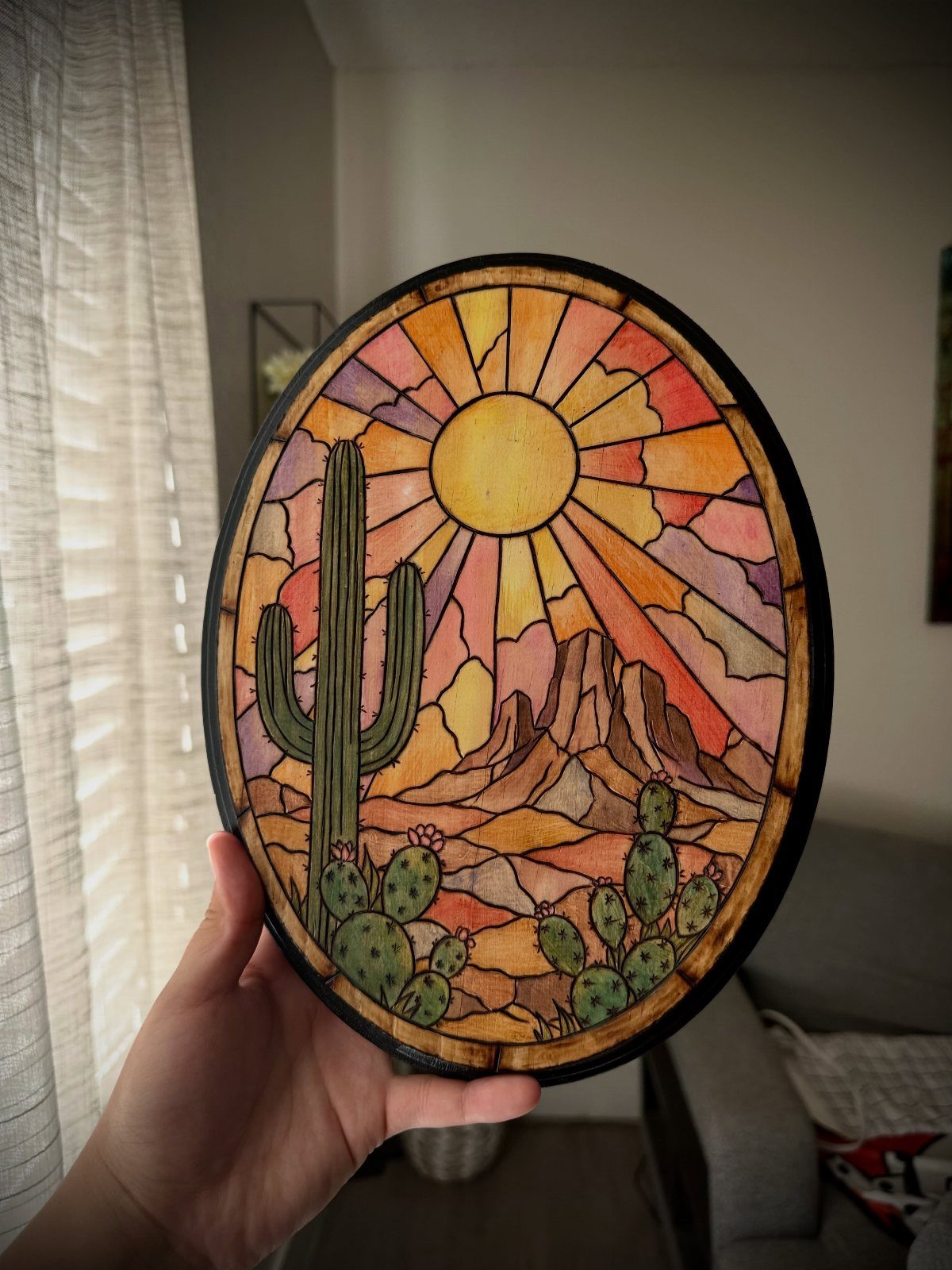 What Can You Do With Burned and Stained Wood? 5 Ideas 2 Circular wooden plaque with colorful stained desert landscape and burnt wood outlines.