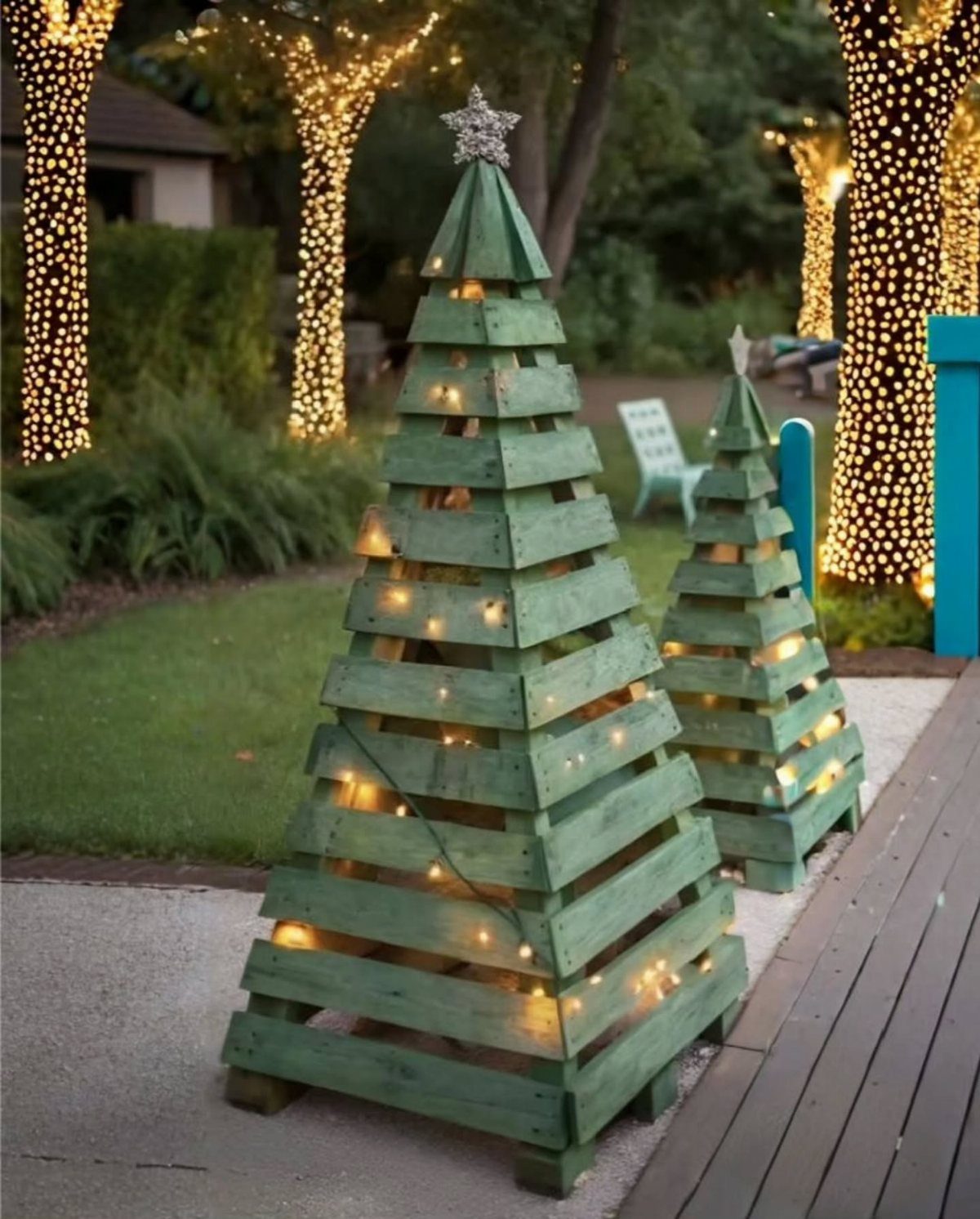 12 Christmas Decorations DIY for Outdoor Spaces 2 Green wooden pallet Christmas trees with glowing lights on a garden path.