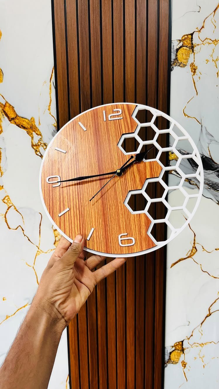 CNC Router Projects and Ideas: 10 Wood Pieces to Make 3 Circular wall clock with wooden face and white honeycomb cutout held by a hand.