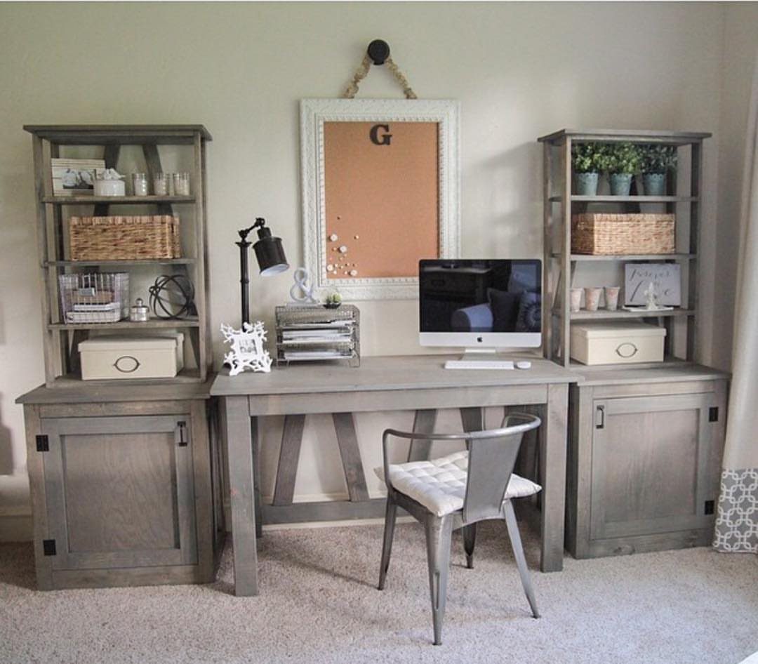 Grey wooden desk with computer and matching side shelves in a home office
