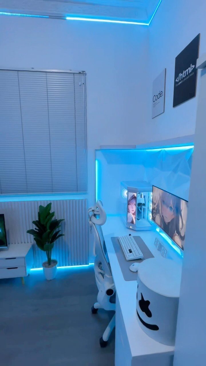 White modern computer desk with blue LED lighting, gaming monitor, and white chair.
