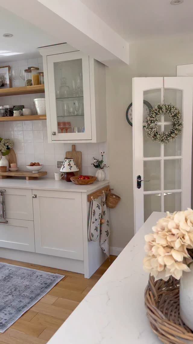 14 DIY Home Decor Wood Ideas for Every Room in the House 13 Wooden open shelves on a white tiled kitchen wall holding various storage jars.