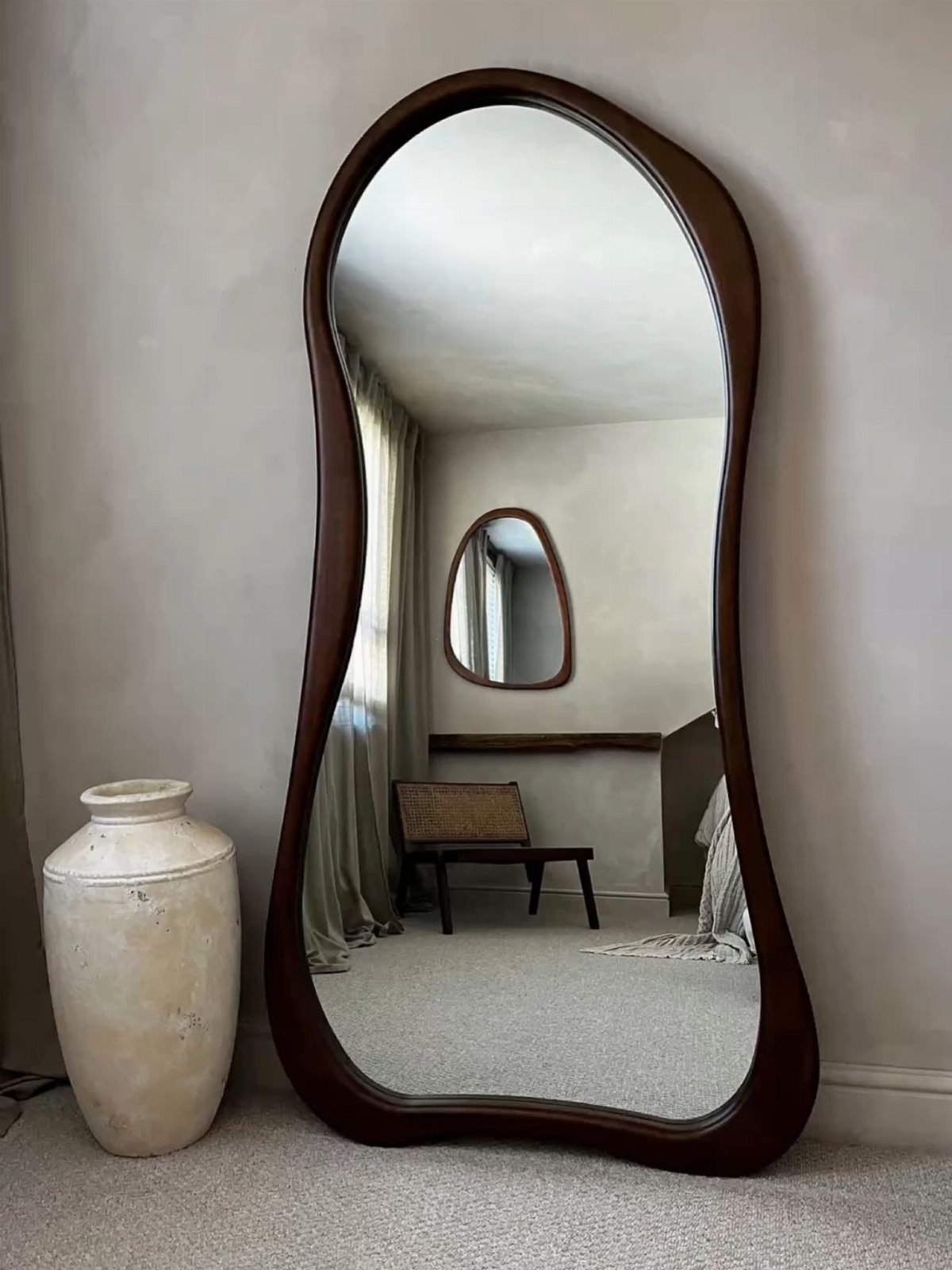14 DIY Home Decor Wood Ideas for Every Room in the House 3 Irregularly shaped full-length mirror with a dark brown wooden frame leaning against a wall.