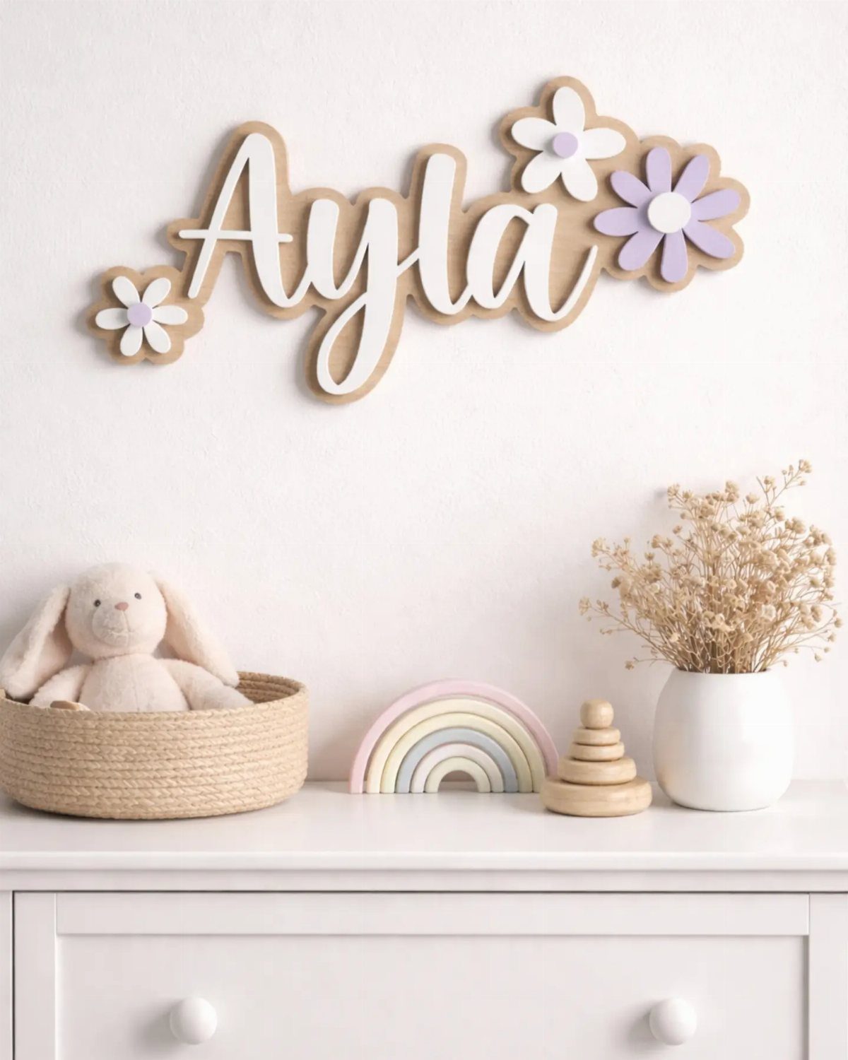 14 DIY Home Decor Wood Ideas for Every Room in the House 1 Wooden name sign spelling Ayla with floral accents on a white wall.