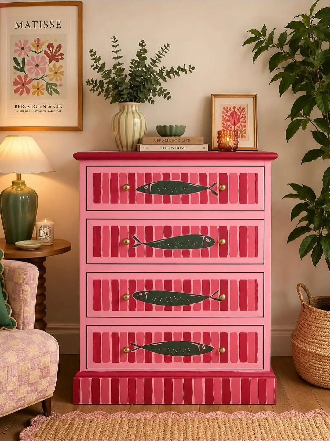 Pink striped dresser featuring unique dark green fish-shaped drawer pulls with gold accents.