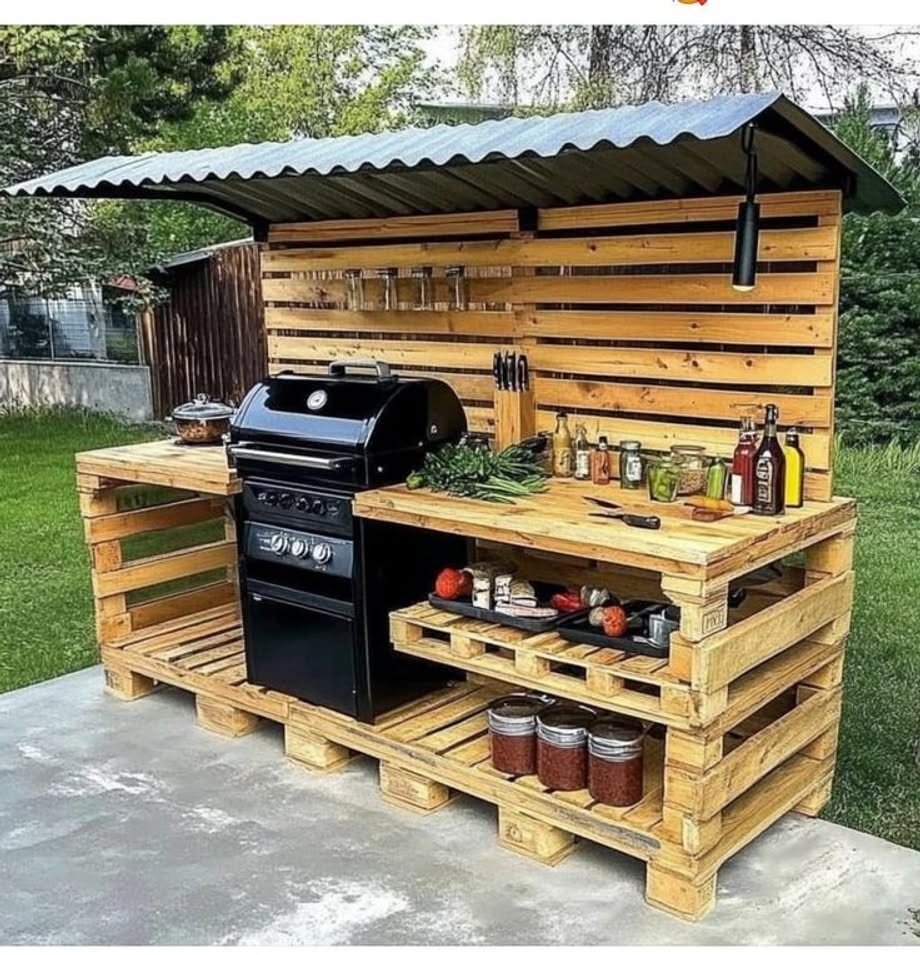 5 DIY Pallet Gazebo Ideas for Backyard Shade and Seating 5 Wooden pallet grill gazebo with a black gas grill and corrugated metal roof.