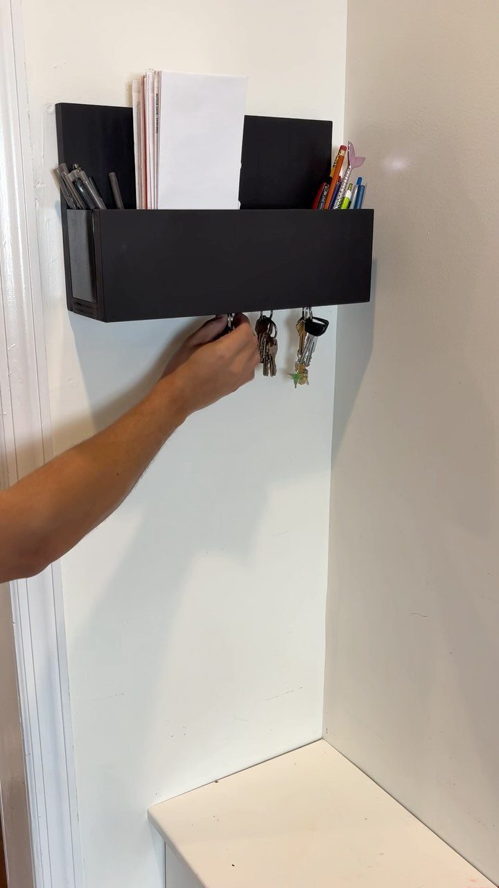 14 Easy Things to Make Out of Wood for Beginners 11 Black wall-mounted key holder with keys hanging and a shelf for mail.