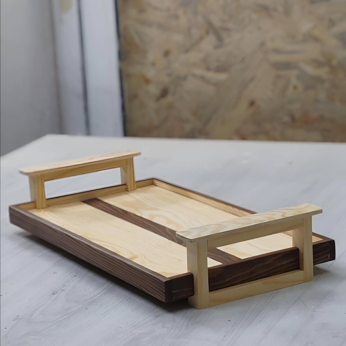 14 Easy Things to Make Out of Wood for Beginners 6 Wooden serving tray with light and dark brown stripes and two handles.