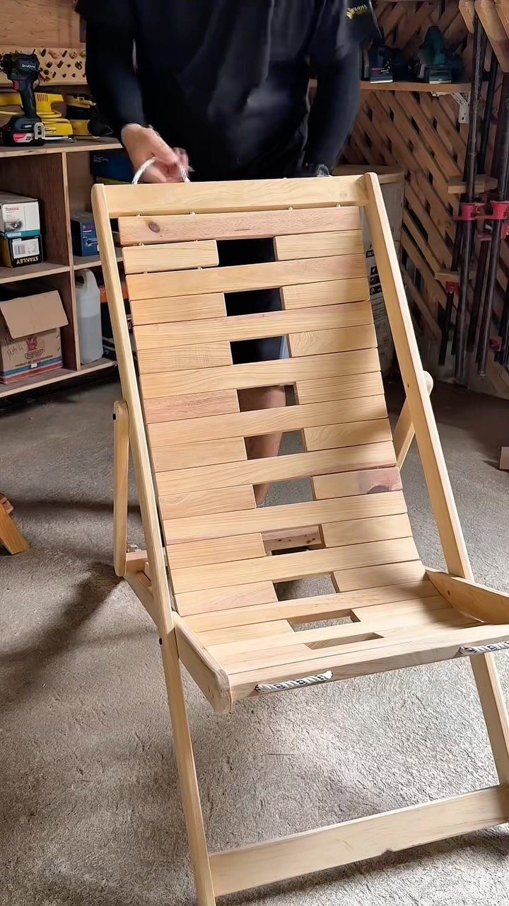 9 Easy to Make Furniture Ideas for Beds, Benches and More 6 Handmade wooden lounge chair with light-colored slats in a home workshop setting.