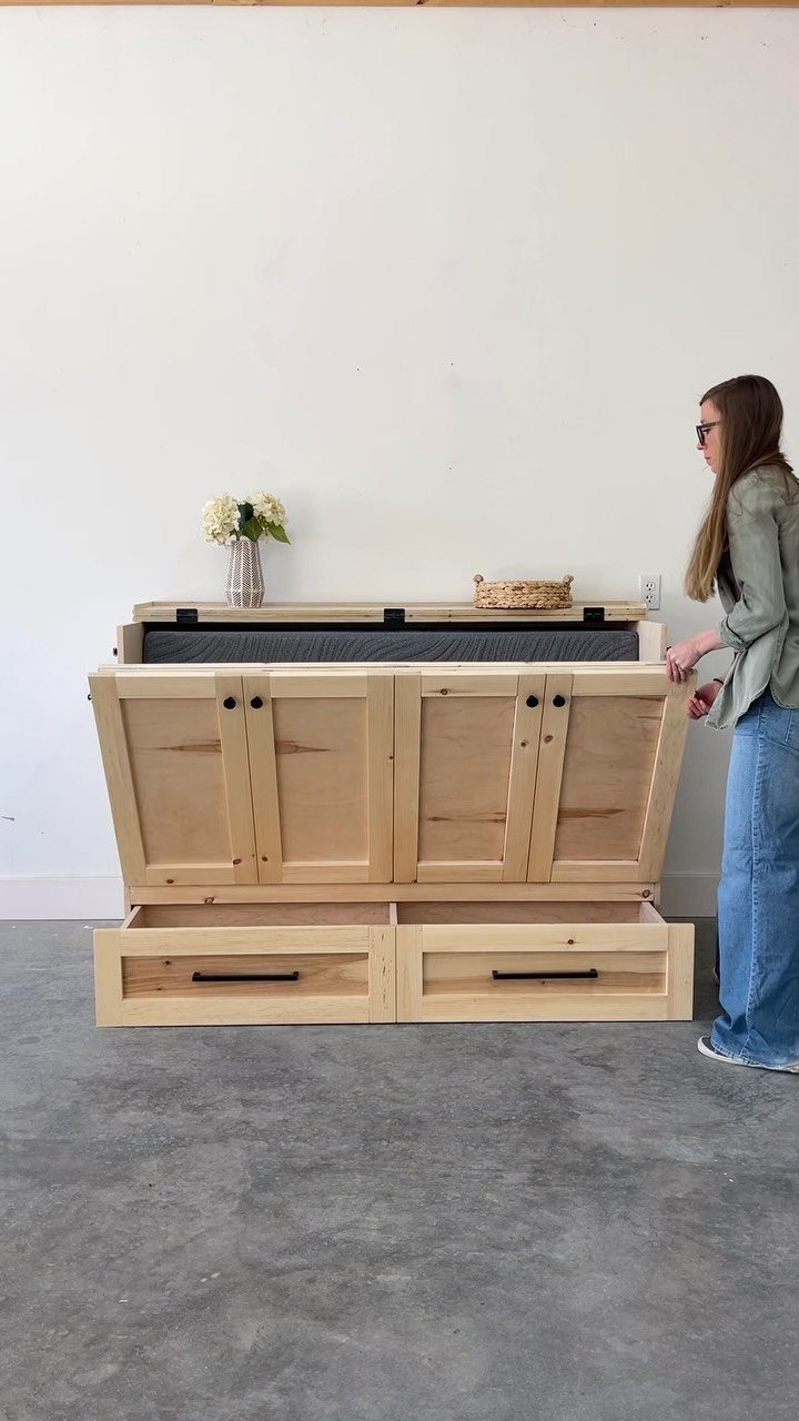 9 Easy to Make Furniture Ideas for Beds, Benches and More 7 Wooden storage bench with open drawers and a woman standing beside it.