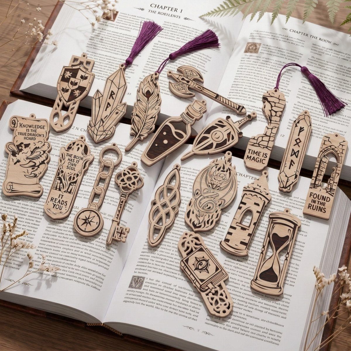 Assorted laser-cut wooden bookmarks resting on the pages of an open book.