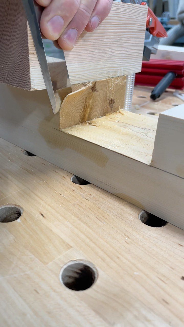 Furniture Making Tools: 11 Hand and Power Tools to Own 7 Hand saw cutting through a light wood block on a professional workbench.