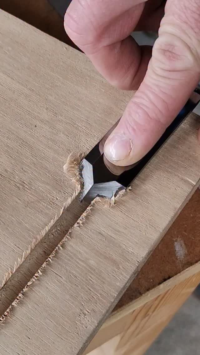 Furniture Making Tools: 11 Hand and Power Tools to Own 6 Hand using a black marking knife to score a line into a wooden board.