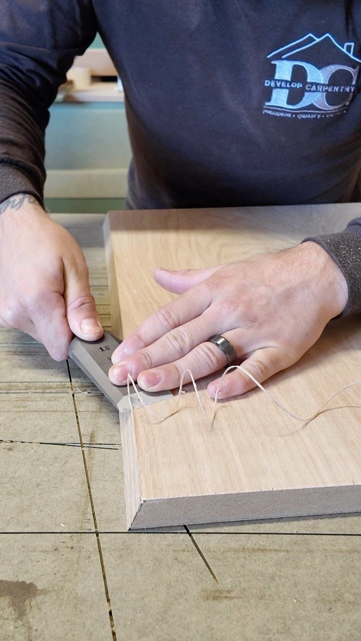 Furniture Making Tools: 11 Hand and Power Tools to Own 11 Hands using a metal marking gauge on a light wooden board.