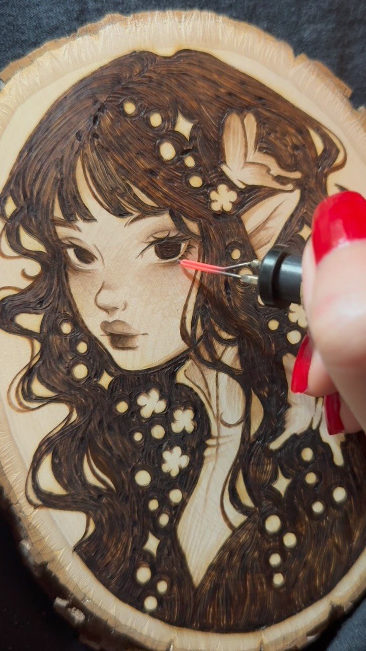 How to Burn Wood Art: 12 Ideas for Every Skill Level 1 Pyrography tool burning a detailed portrait of a girl into a natural wood slice