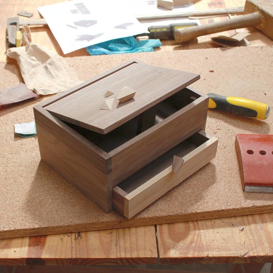 Handmade wooden jewelry box with drawer on a workbench with woodworking tools