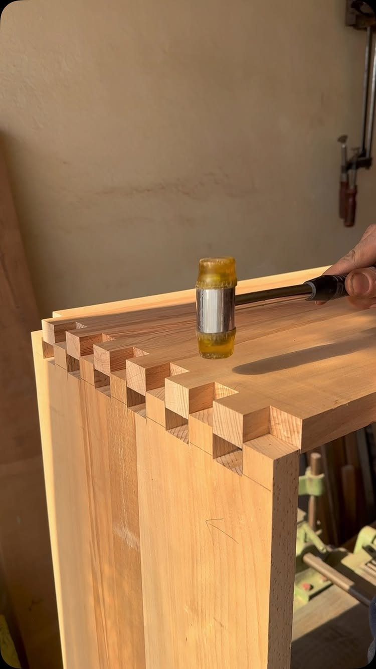 Joining Wood Together: 4 Ideas for Strong Joints 1 Rubber mallet hammering a wooden board into a box-joint woodworking connection.
