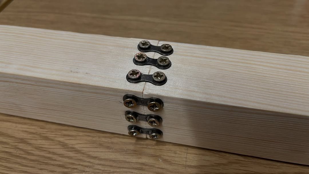 Joining Wood Together: 4 Ideas for Strong Joints 3 Wooden beams joined end-to-end using small metal mending plates and screws