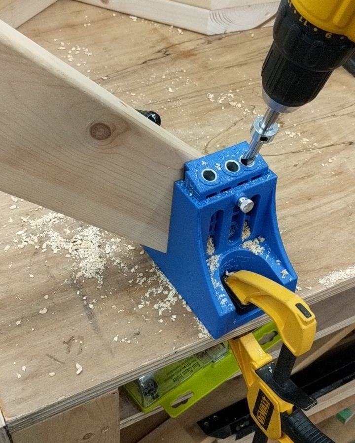 Joining Wood Together: 4 Ideas for Strong Joints 2 Power drill driving a screw into wooden boards using a blue pocket-hole jig.