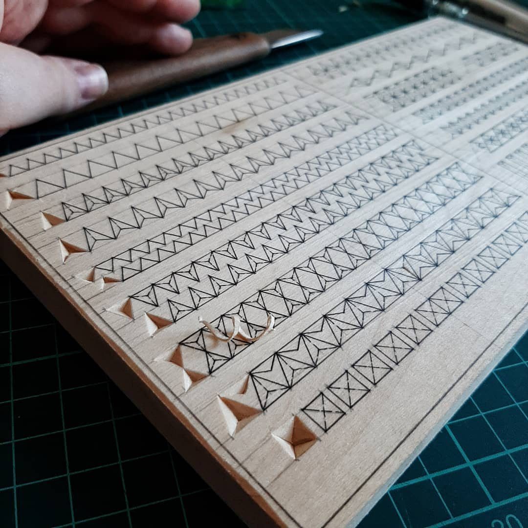 Learn How to Carve Wood: 4 Ideas to Start With 2 Wooden board with geometric chip carving patterns being carved by a hand tool.