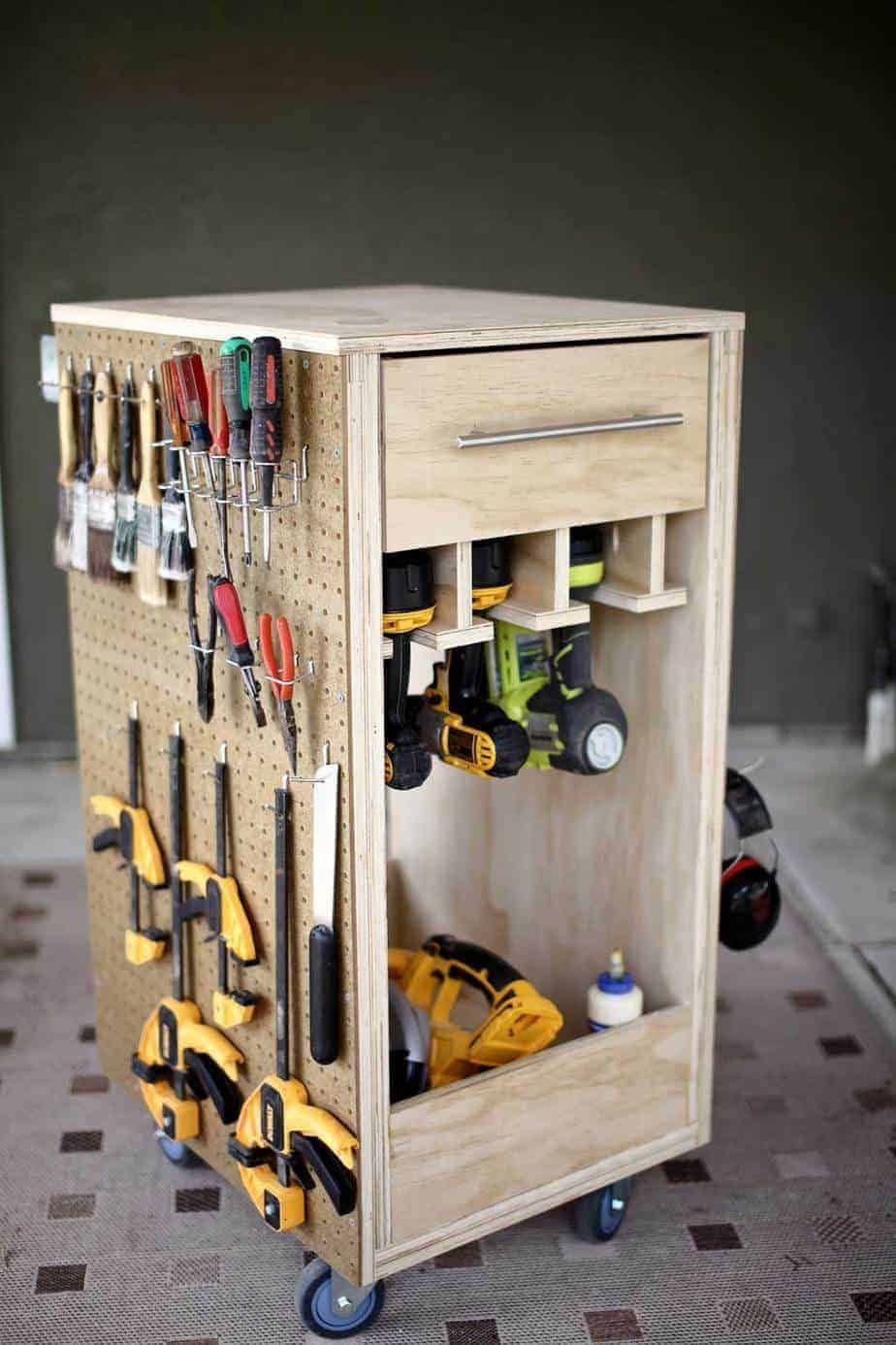 Mobile Tool Cabinet Ideas: 5 Options for Your Garage 4 Wooden DIY mobile tool cabinet with pegboard, drawer, and caster wheels holding various tools.
