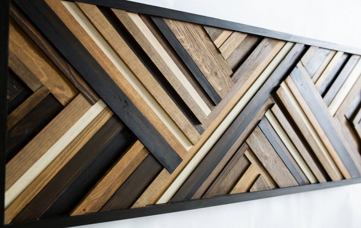 Geometric wall art made from multi-toned wooden strips arranged in a 3D pattern.