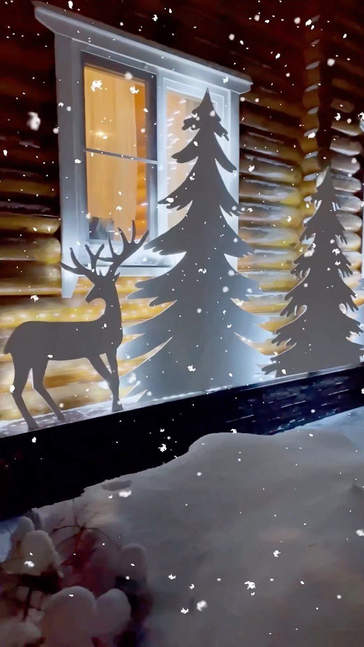 Wooden silhouettes of pine trees and a deer outside a log cabin window.