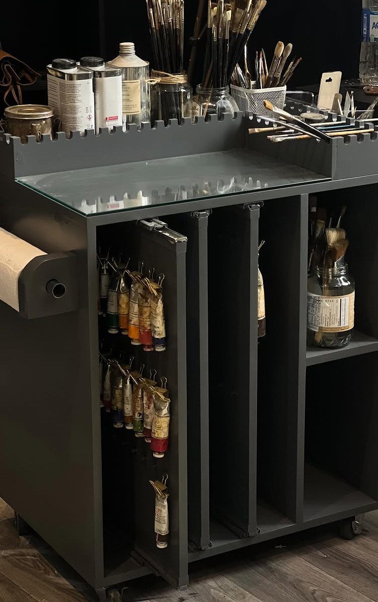 Paint Storage Cabinet Ideas: 6 Options for Art and Workshop 1 Grey rolling art storage cabinet with paint tubes, brushes, and a paper roll.
