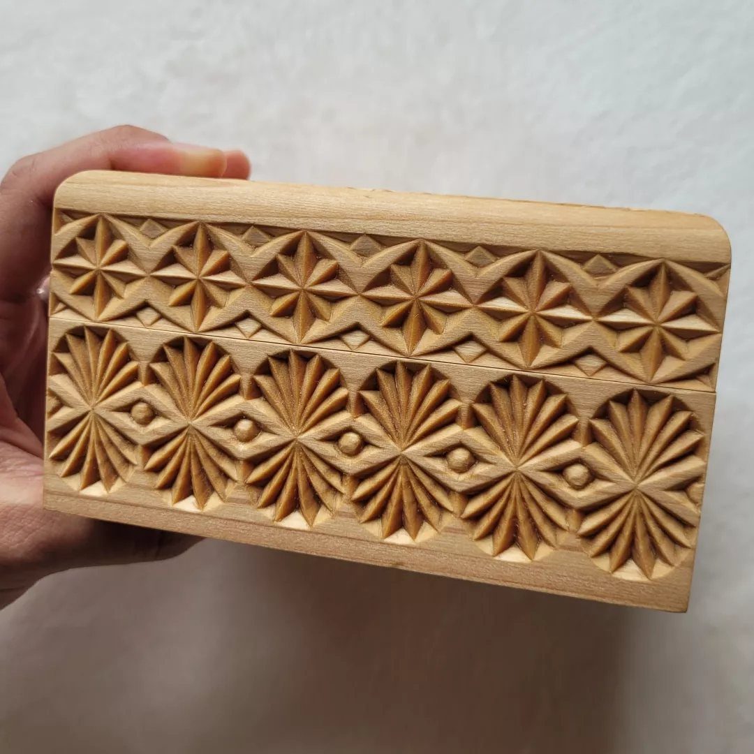 Relief Wood Carving Ideas: 5 Projects to Try at Home 2 Wooden block with intricate geometric relief carvings of stars and floral patterns.