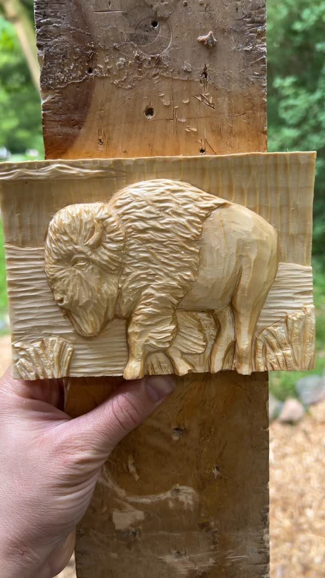 Relief Wood Carving Ideas: 5 Projects to Try at Home 1 Wooden relief carving of a bison held up against a rustic wooden post.