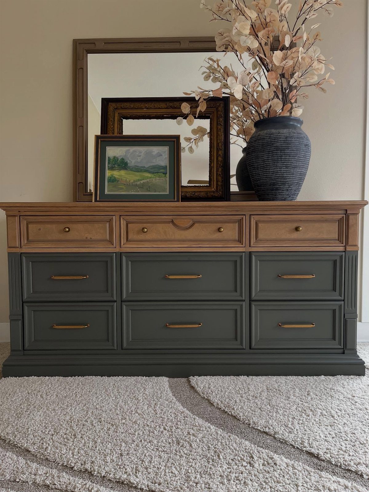Dark grey-green painted dresser drawer fronts with natural wood top and gold handles.