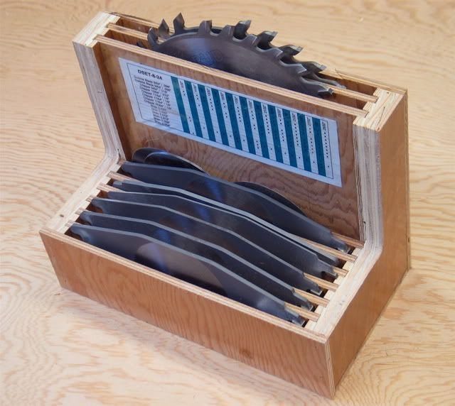 Wooden dado blade case holding several circular saw blades with a reference chart.