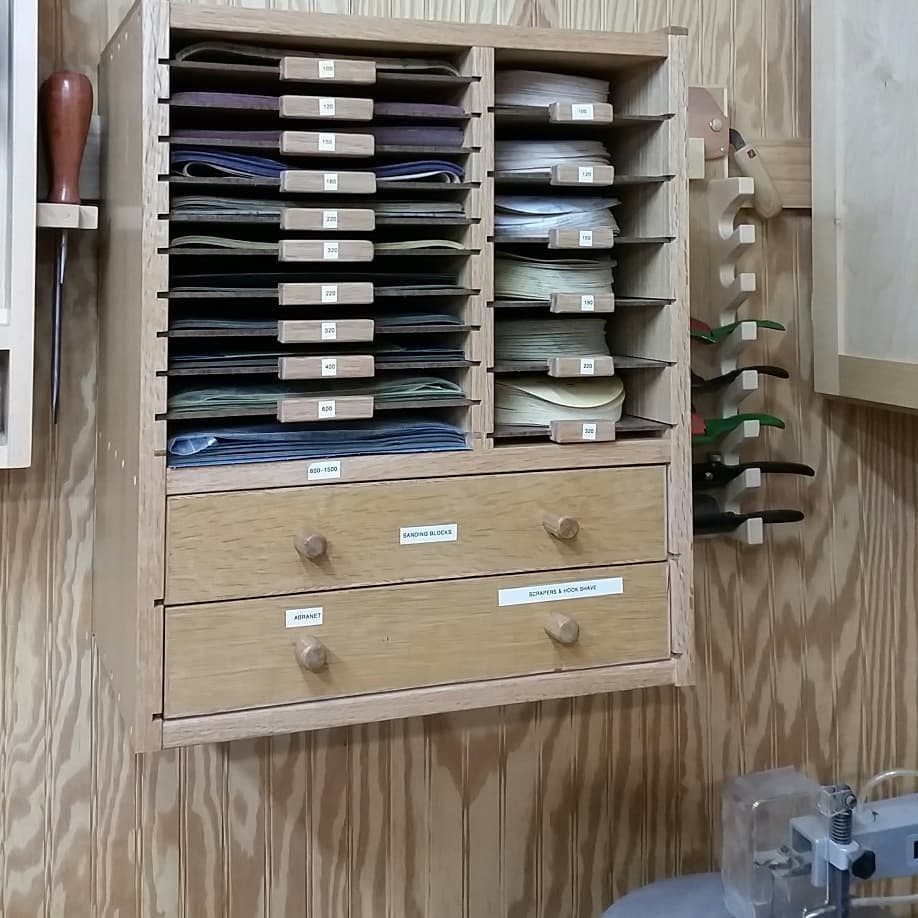 14 Shop Class Projects to Build: Bookshelf to Plywood Cart 14 Wooden wall-mounted organizer with multiple slots and drawers for storing materials.