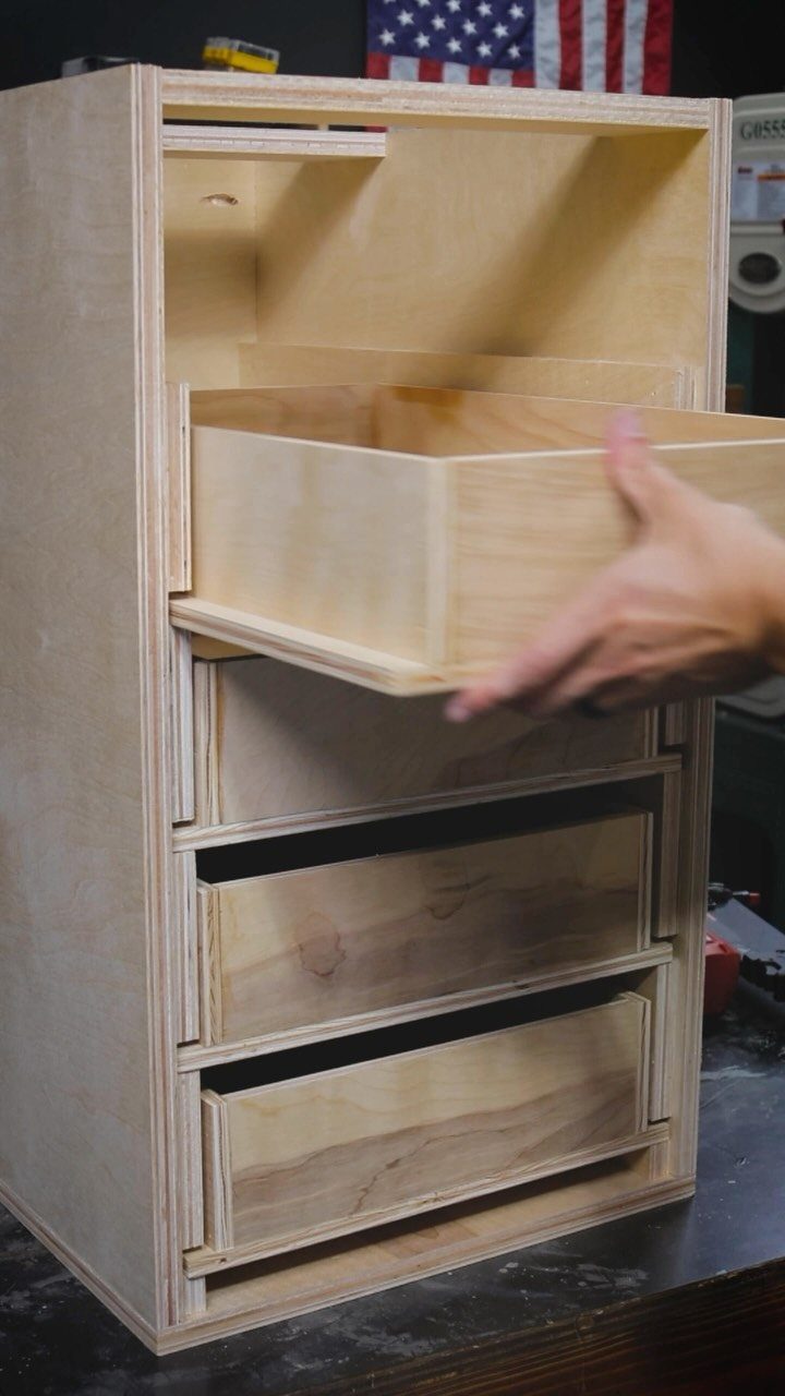 14 Shop Class Projects to Build: Bookshelf to Plywood Cart 2 Plywood tool storage cabinet with drawers being opened on a dark workbench