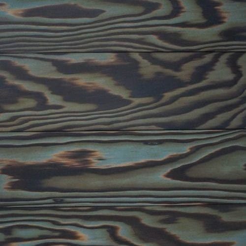 Charred wooden planks with a blue-grey color stain highlighting the natural grain.