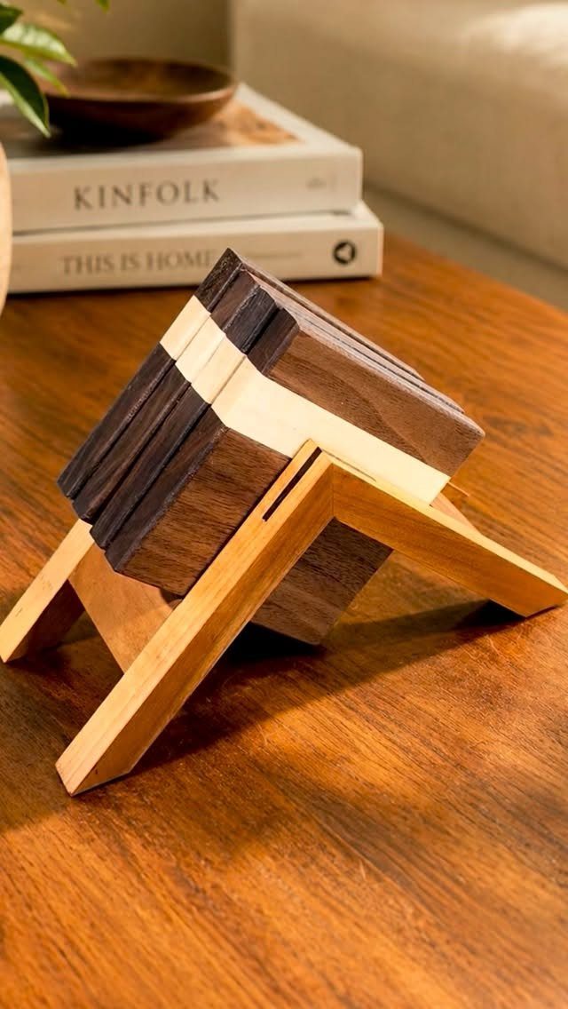 12 Small Wood Projects for Beginners to Build This Weekend 10 Wooden coasters in a matching stand resting on a polished wooden table.