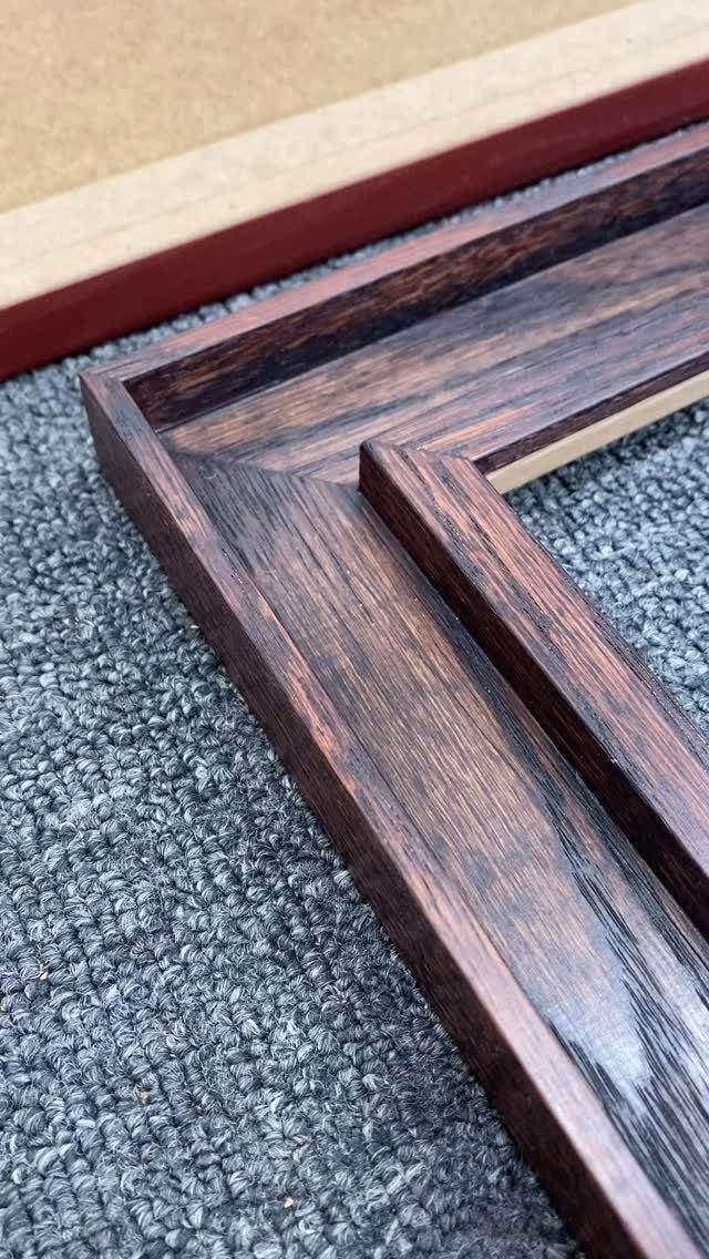 12 Small Wood Projects for Beginners to Build This Weekend 3 Dark brown polished wooden picture frame with mitered corners on grey carpet.