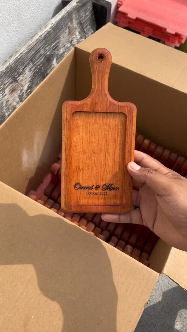 12 Small Wood Projects for Beginners to Build This Weekend 6 Small wooden serving tray with a handle and engraved text held over a box.