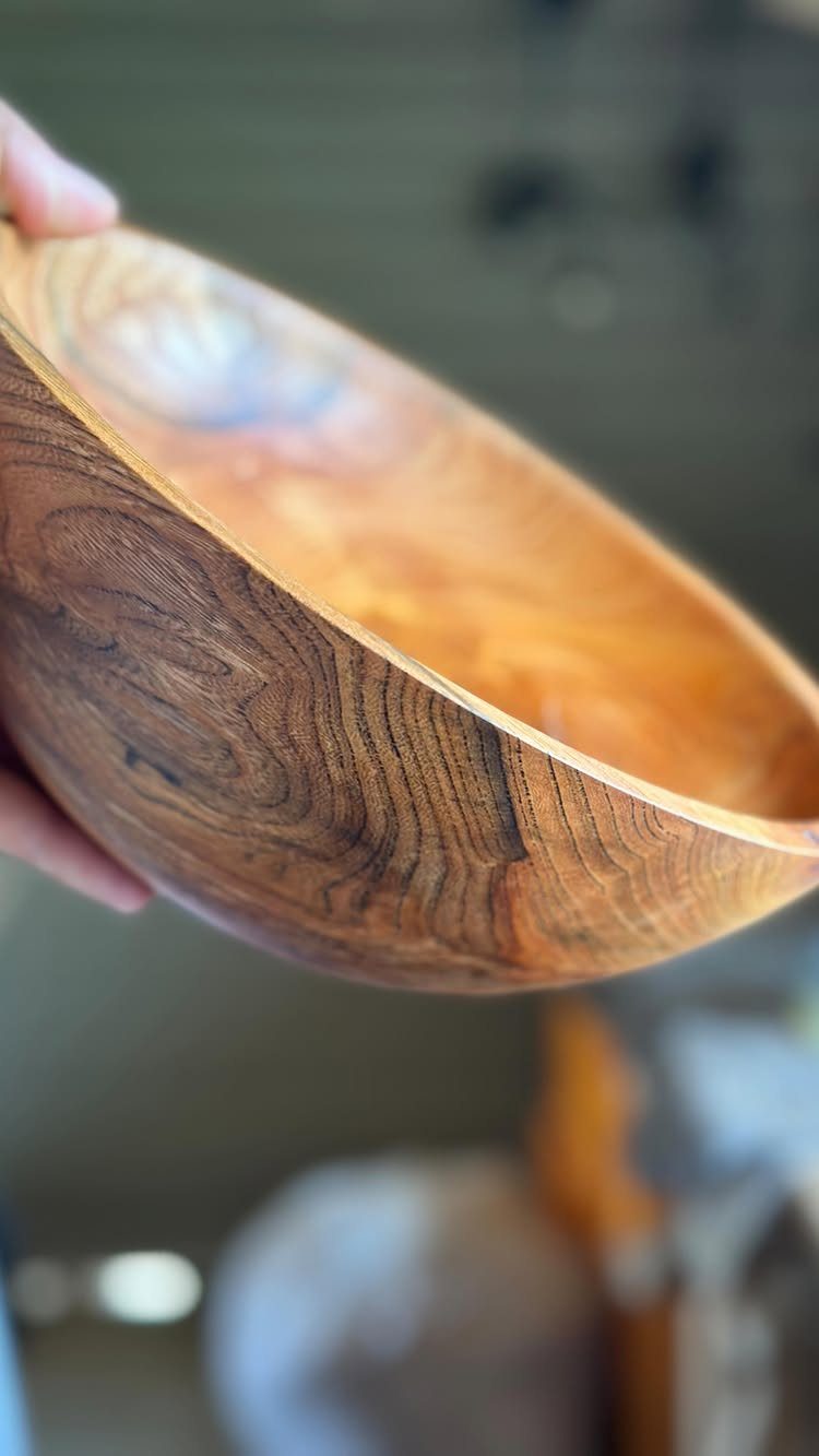 12 Small Wood Projects for Beginners to Build This Weekend 7 Wooden bowl with natural grain held by a hand against a blurred background