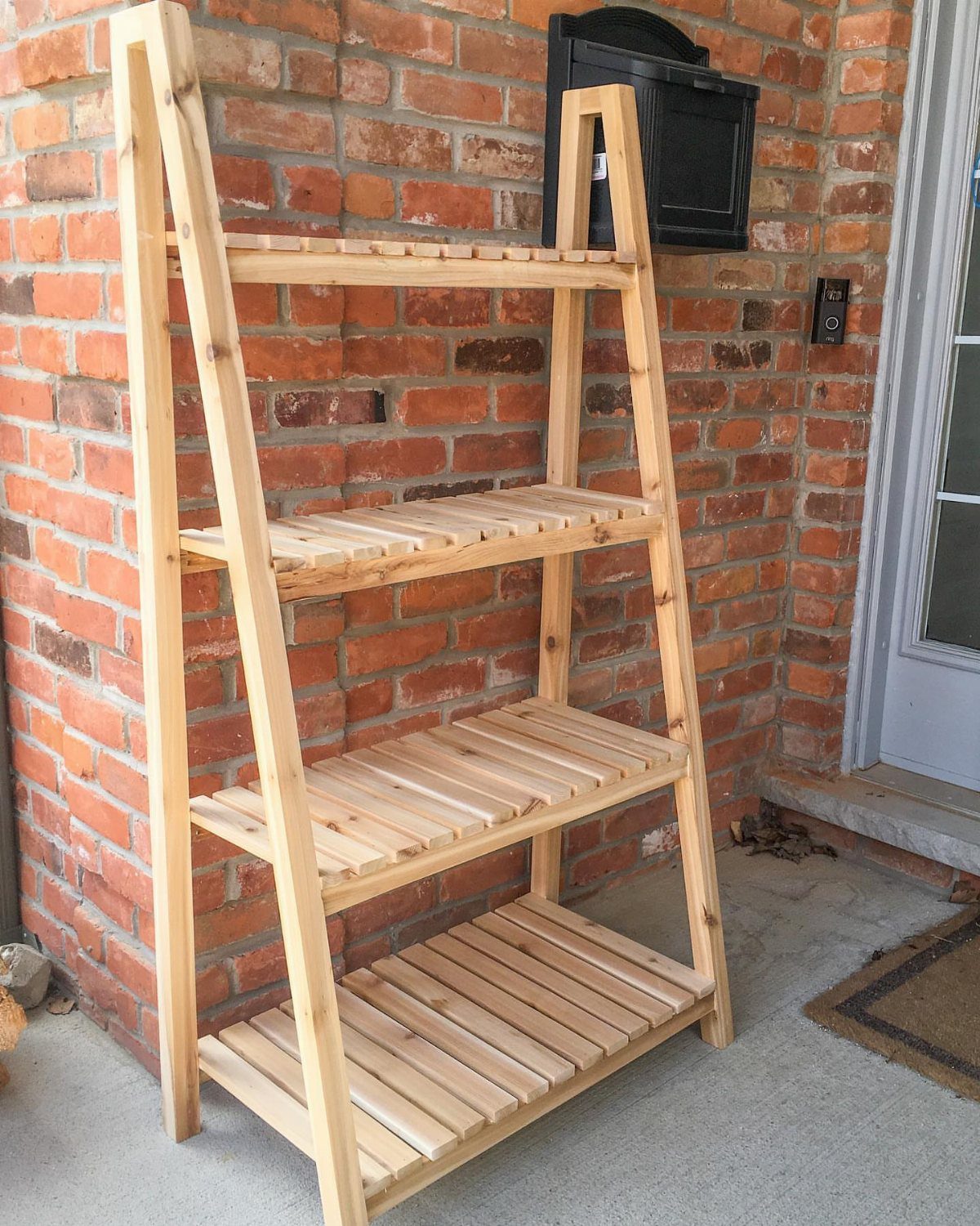 Small Wooden Rack Ideas: 9 Shelves, Stands and Holders 6 Light wood A-frame shelf with four slatted tiers against a red brick wall.