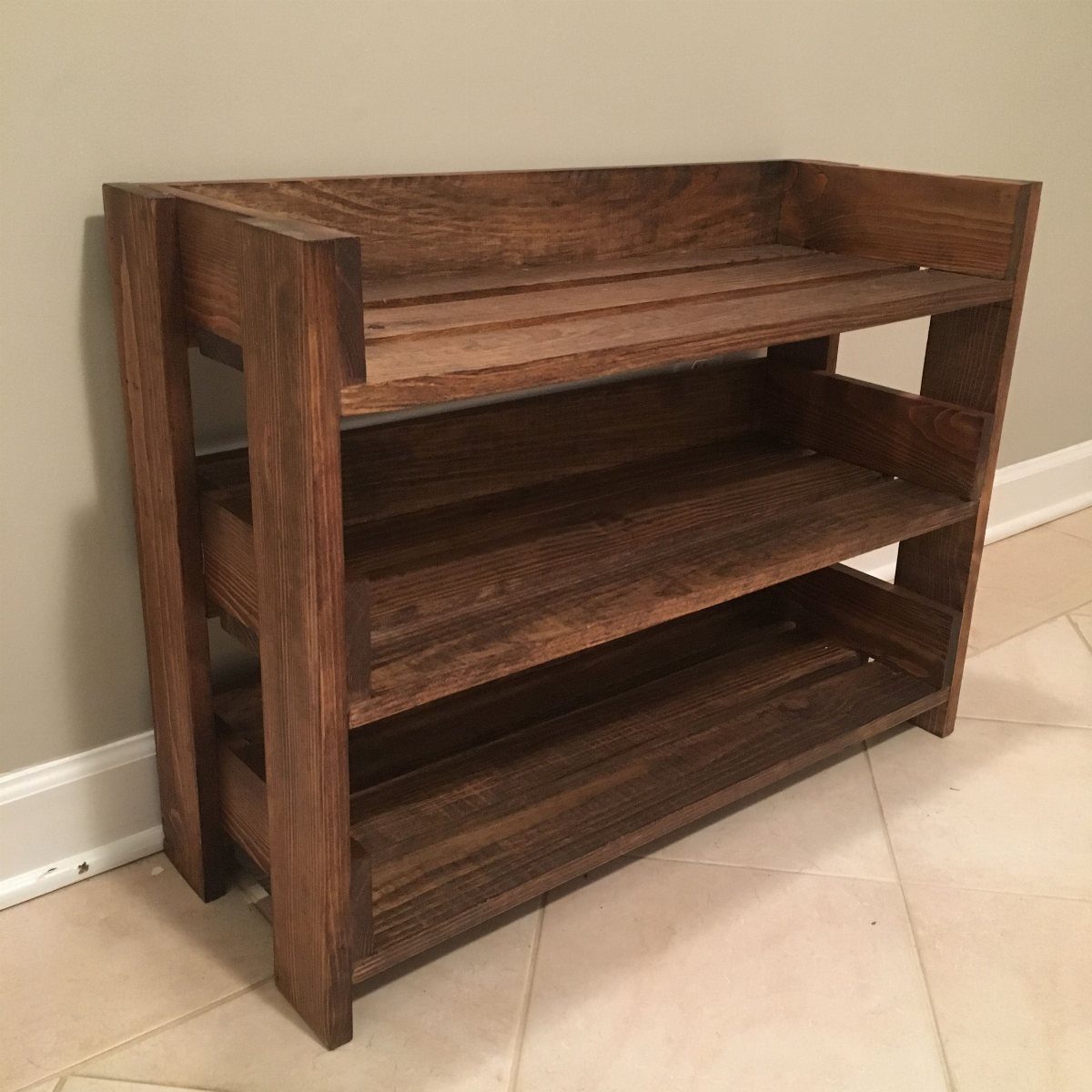 Small Wooden Rack Ideas: 9 Shelves, Stands and Holders 5 Dark stained wooden shoe rack with three tiers on a tiled floor.