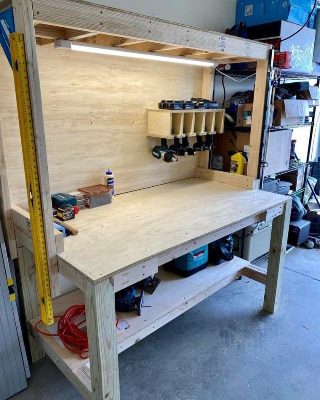 Small Woodworking Bench Ideas: 5 Designs for Tight Spaces 1 Wooden homemade workbench with a lower shelf and tool rack for power drills