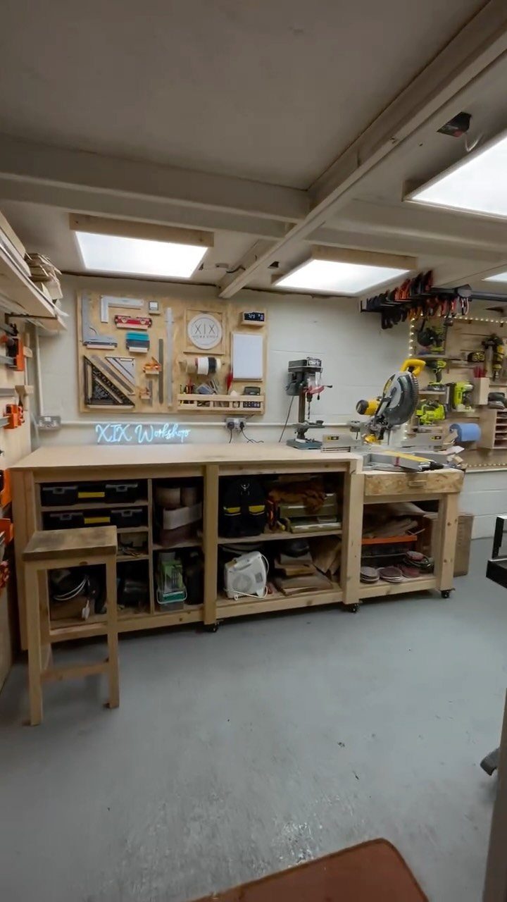 Wooden workbench and power tools in a well-organized small home woodworking workshop.