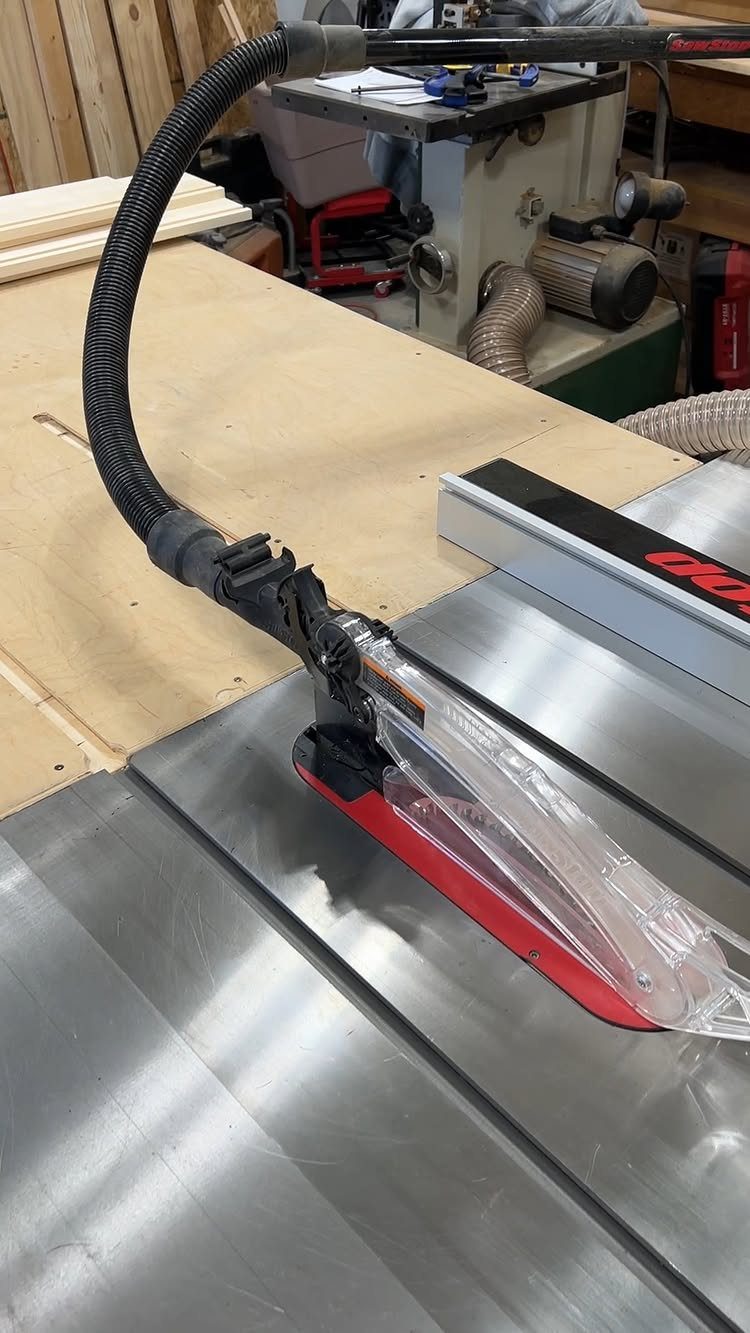 Table Saw Dust Collection: 5 Ideas for a Cleaner Shop 4 Table saw with a black flexible dust collection hose attached to the blade guard