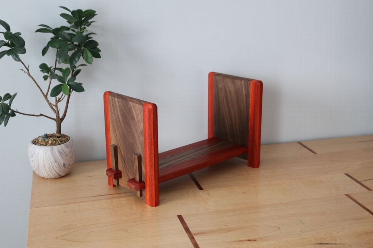 Table Saw Projects: 15 Ideas to Build This Weekend 4 Wooden book rack with reddish and dark brown tones on a light table.