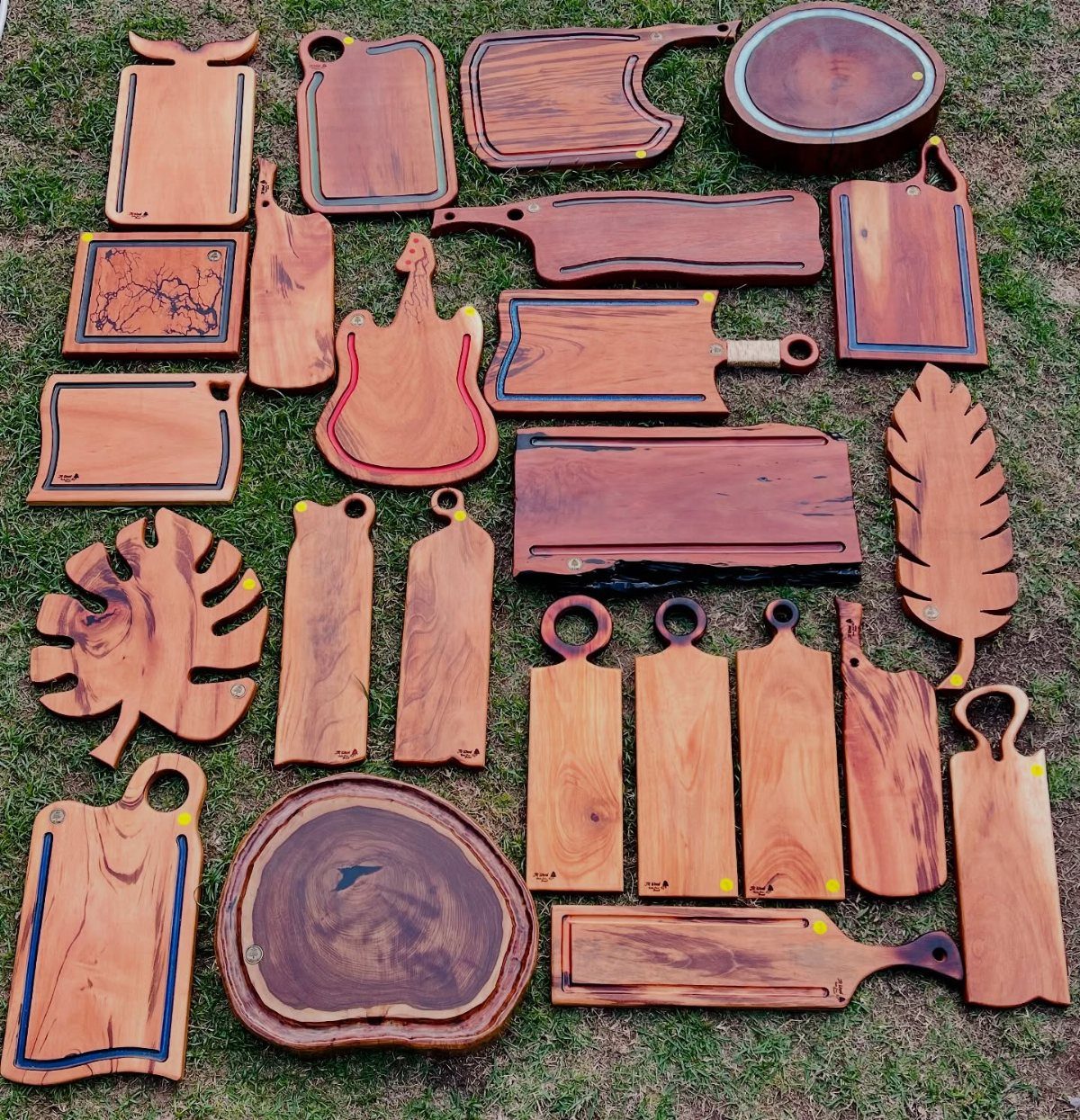 Table Saw Projects: 15 Ideas to Build This Weekend 7 Various wooden charcuterie boards in different shapes and sizes laid out on green grass.