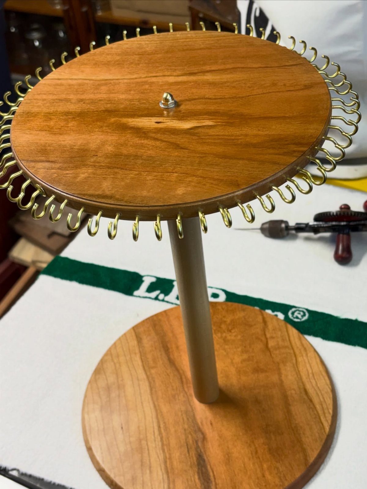Table Saw Projects: 15 Ideas to Build This Weekend 8 Wooden earring holder with gold hooks around the top circular plate.