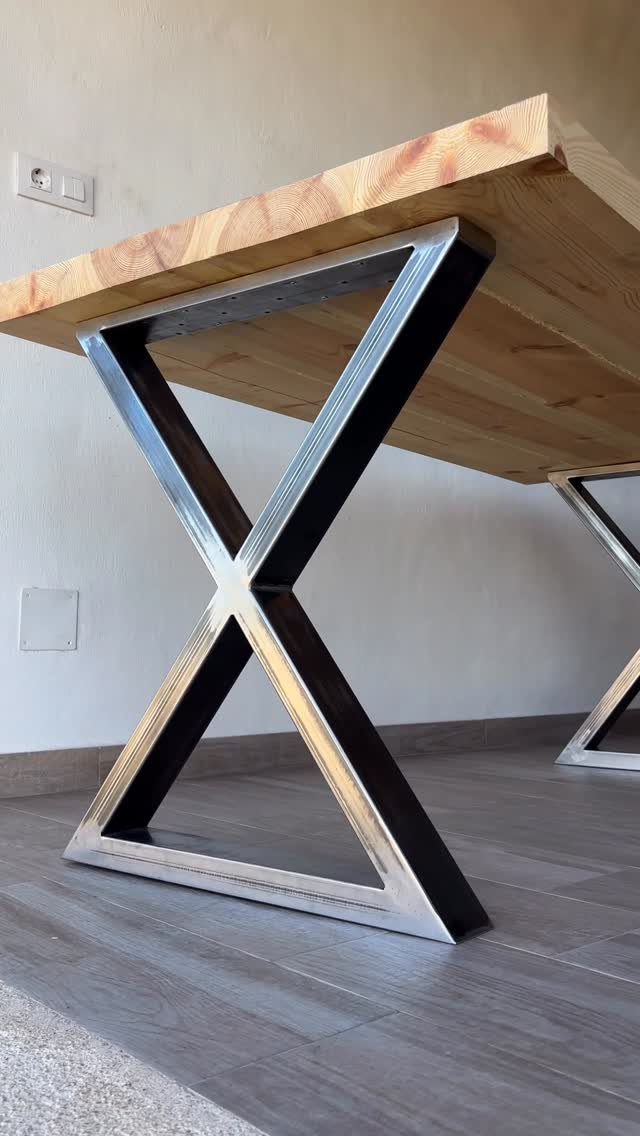Table Saw Projects: 15 Ideas to Build This Weekend 15 Wooden tabletop with polished metal X-shaped legs against a white wall.