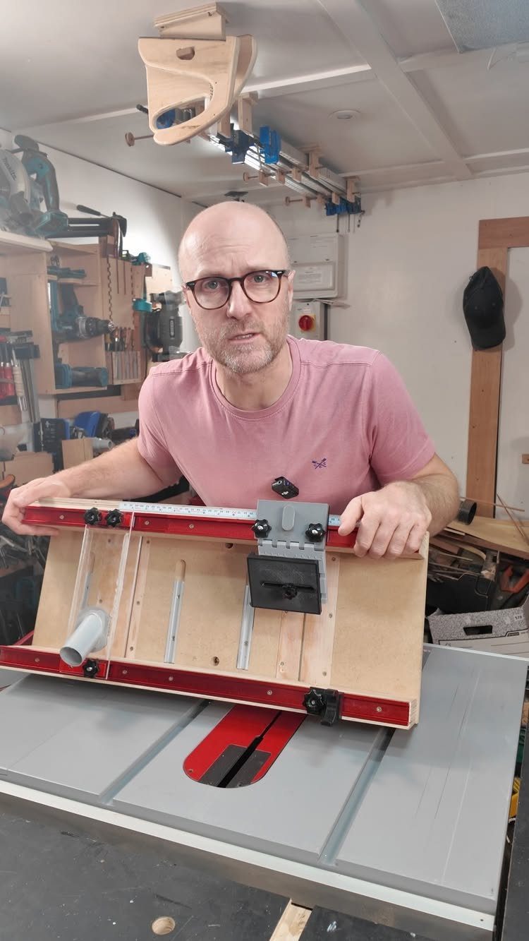 Table Saw Projects: 15 Ideas to Build This Weekend 1 Man holding a wooden table saw crosscut sled in a woodworking workshop.
